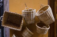 Baskets hung on a wall are decorative and functional.