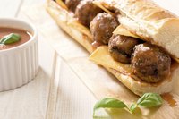 Use cheddar cheese and fresh basil for a different kind of meatball sub sandwich.