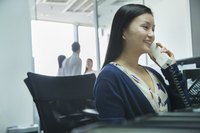 Woman using phone in office environment.