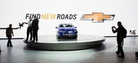 A display car on a circular stand during an auto show.