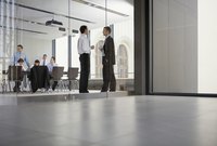 Workers in a board room having a meeting.