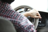 Driver with hand on wheel