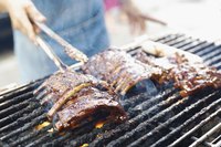 Barbecued ribs over the fire on the grill.