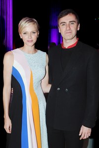 Head Dior designer Raf Simons appears with Princess Charlene of Monaco at a cocktail party marking the Dior Cruise Collection 2014.