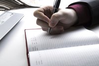 Close-up of hand making list