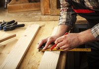 Carpenter making a measurement.