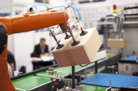 A robotic arm packaging products in a production facility.