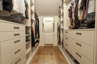 Walk-in closet with simple floor.