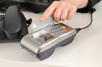 Close-up man swiping a credit card.