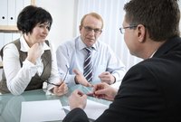 A married couple meeting with a lawyer