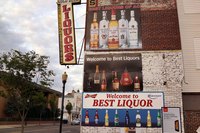 A liquor store exterior on a street corner.