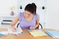 Young adult woman looking over tax documents