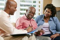 Financial advisor speaking to a mature couple at home