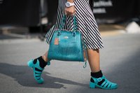Woman wearing blue jelly shoes.