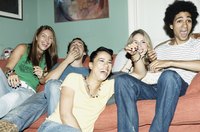 Friends laughing and watching tv together