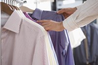 Examine garment tags to confirm whether your clothing is made of cotton, polyester or a blend of the two fibers.