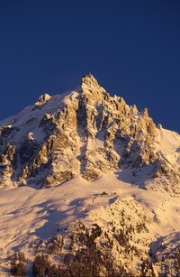 Take the time to paint and decorate your paper mache mountain range to make it look like the real thing.