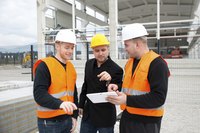 A group of people on the job site holding a meeting.
