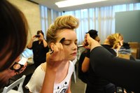 A model prepares at a Declare Your Denim fashion show. Your teens can shine on the runway, too -- with you as organizer.