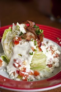 Iceberg lettuce and a thick, creamy dressing are the foundation of a wedge salad.