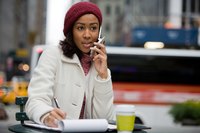 A young businesswoman is having a discussion on her phone.