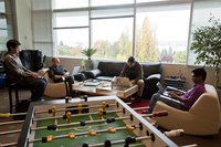 Software developers working together in an office lounge.