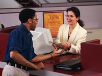Bank teller handing cash to a customer.
