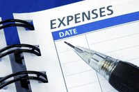 A cashledger with a pen on it.