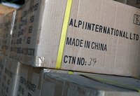 A stack of packed boxes on a shelf ready for shipping.
