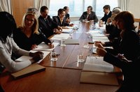 Business people sitting around a conference table.