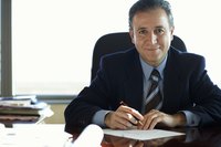 Businessman making a list at his desk.