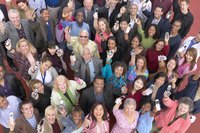 Individuals holding up their cell phones.