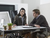 A disabled worker is at her desk.
