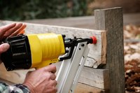 Close-up of air blow gun being used on fence construction