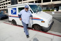 A postal worker outside his USPS truck