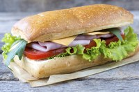 Panini sandwich on a wood surface.