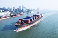 A cargo ship arriving in a city port