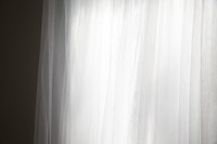 Cotton voile curtains allow light to shine through.