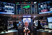 The New York Stock Exchange floor with trading data displays.