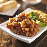 Chinese-American orange chicken sauce is served with pieces of deep-fried, battered chicken.