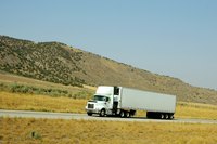 Truck driving on empty highway
