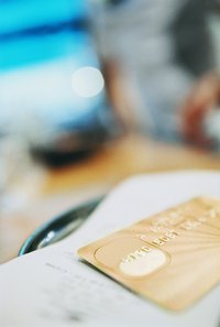 Close-up of a credit card layoing on a receipt in a cafe.