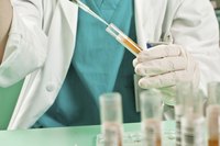 A lab technician with a test tube.