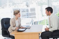 Two people in the business office are having a discussion.