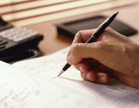 Hand using a pen to write in a schedule.