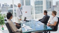 A group of colleagues are sitting in a business meeting.