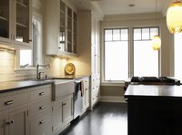 An apron sink wraps down over the cabinet face.