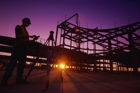 Silhouette of construction workers at a site at night