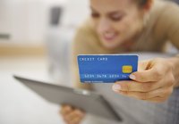 Woman holding up credit card