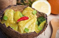 A curry dish served in a bowl made from a coconut shell.